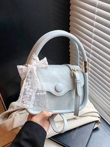 Light blue patent leather mini handbag with lace bow and adjustable crossbody strap