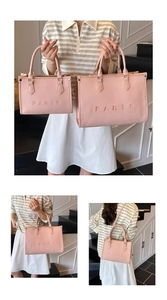 Detail view of pink woven tote bags with PARIS embroidery in large and small sizes