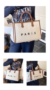 Detail view of large canvas tote bag with leather trim and Paris print lettering