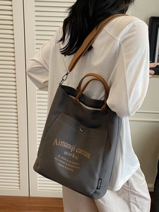 Deep grey minimalist canvas tote bag with brown straps and large capacity for women