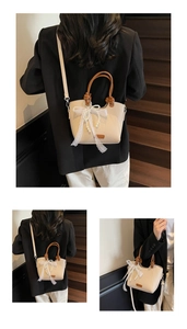 Détail d'un sac cabas beige avec anses tressées marron, nœud en dentelle et perles
