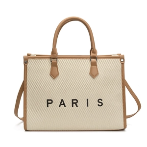 Large off-white canvas tote bag with brown leather trim and Paris lettering on front
