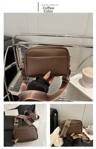 Detailed view of coffee brown lychee pattern square bag with a striped canvas shoulder strap