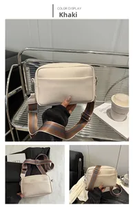 Detail of khaki crossbody bag showing lychee grain texture and striped fabric strap
