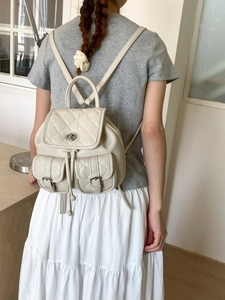 Beige quilted leather backpack for women with metal twist lock and dual front pockets