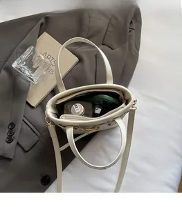 Internal view showing large storage space of white crocodile pattern bucket bag