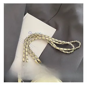 Detail der silbernen Metallkette verflochten mit cremefarbenem Leder am Bucket-Rucksack