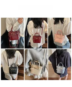 Detail view of stylish small bucket bags in multiple colors with adjustable shoulder straps