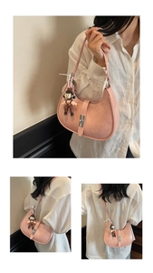 Detailed view of pink dumpling bag with pleated texture and vintage lock detail