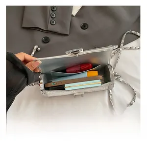Detail of silver embossed cylinder bag interior showing ample storage and card slot