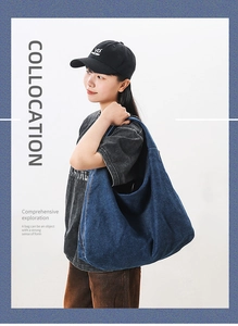 Detail of blue denim tote bag showing spacious capacity and natural fold texture