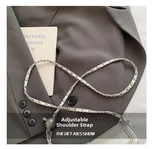 Detail of silver chain strap with gray woven leather and ball adjustment buckle