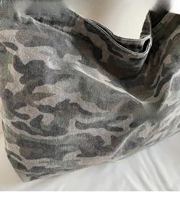 Macro shot of durable washed canvas tote bag featuring a classic camouflage pattern texture