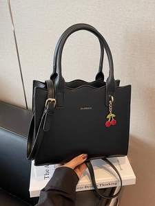 Elegant black wave-edge tote bag with cherry charm and adjustable strap for women