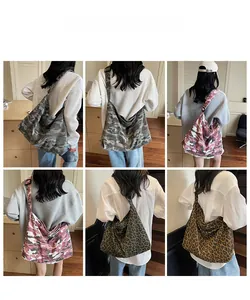 Detail showing various leopard and camo canvas tote bags with wide adjustable straps