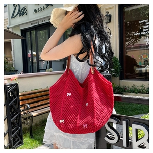 Red hand-woven crochet tote bag featuring pink 3D bows and premium brown leather straps