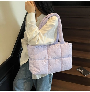 Macro view of light purple quilted tote bag showing plush down-filled padding and texture