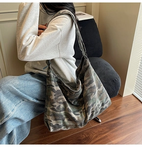 Detail view of large capacity camouflage canvas hobo bag with durable shoulder strap design