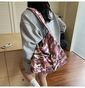 Detail of pink and purple camo canvas tote bag showing high capacity shoulder strap texture