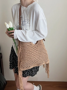 Handmade woven tote bag with fringe tassels and brown leather strap for summer beach vacation