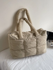 Quilted beige puffer tote bag with padded handles and large capacity for commuting