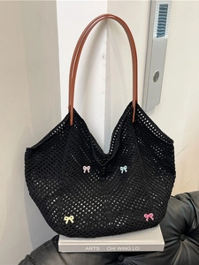 Handmade black crochet tote bag with colorful bows and brown leather straps