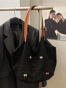 Handmade black crochet mesh tote bag with colorful 3D bows and leather handles