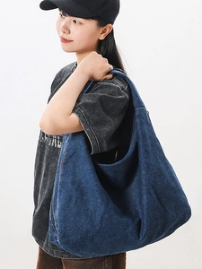 Large dark blue denim shoulder bag for women with a vintage washed finish and tote style