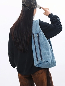 Chic light blue denim tote bag for women with dual vertical zippers on white background