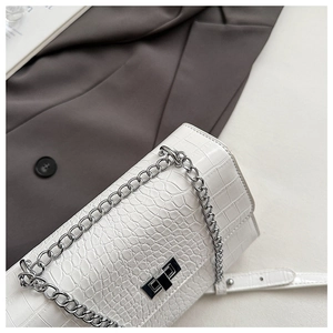 Detailed view of white crocodile pattern PU leather bag with silver chain and twist lock