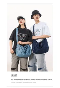 Dual view of large denim messenger bags in light and dark wash on two models