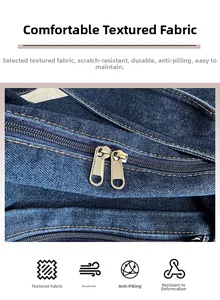 Detail of washed denim bag featuring smooth double gold zippers and durable twill fabric