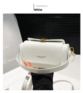 Detail of white semi-cylindrical handbag with gold hardware and fashion leather text