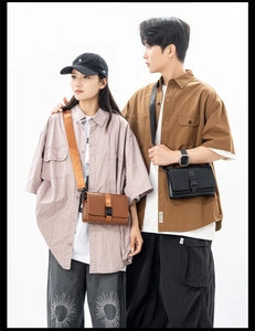 Close-up of minimalist box crossbody bag with buckle closure in brown and black leather