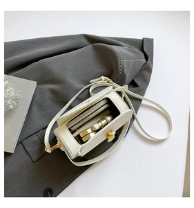 White box-shaped crossbody bag interior showing space for a phone and cosmetics