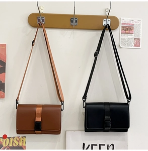 Detailed view of classic black and brown leather messenger bags with adjustable straps