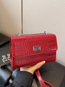 Red crocodile pattern crossbody bag with silver hardware chain strap and turn-lock