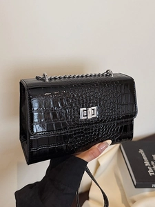 Glossy black crocodile pattern crossbody bag with silver chain strap and metal lock