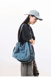 Side view of large washed denim tote bag for women showing spacious design and strap