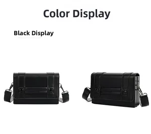 Detail view of black crossbody box bag featuring metallic studs and wide strap