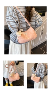 Pink crescent bag with knot strap, pearl heart charm and lace bow details