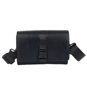 Minimalist black box crossbody bag for men featuring leather texture and nylon buckle strap
