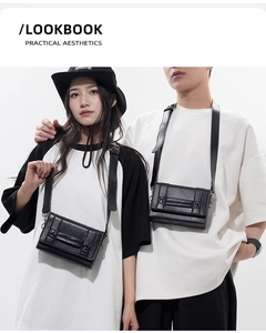 Minimalist black leather crossbody flap bag shown with adjustable straps on models