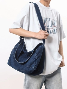 Large dark blue washed denim crossbody bag with wide shoulder strap and vintage style