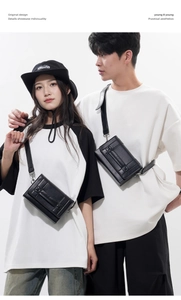 Detail view of the black minimalist crossbody bag featuring a flap and decorative buckle