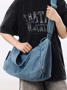 Large washed denim crossbody bag for women with wide strap and casual street style