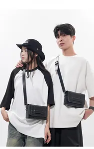 Detail of minimalist black leather crossbody bag with neat stitching and adjustable strap