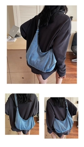 Detailed view of the washed denim hobo bag showing spacious interior and soft fabric