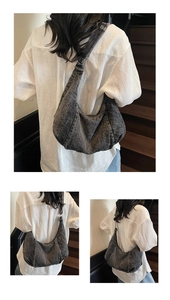 Detail of grey washed denim hobo bag with adjustable strap and silver metal buckle