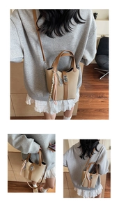 Detailed view of straw bucket bag with leather trim, metal twist lock, and woven charm